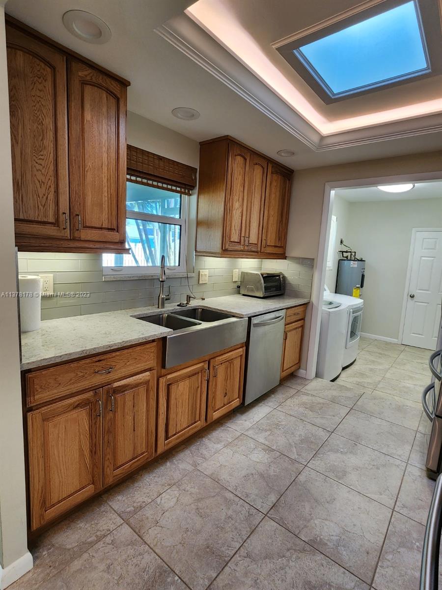 1513 Lance Road Jupiter, FL 33469 - Photo 13 of 33 a kitchen with stainless steel appliances granite countertop a sink and cabinets