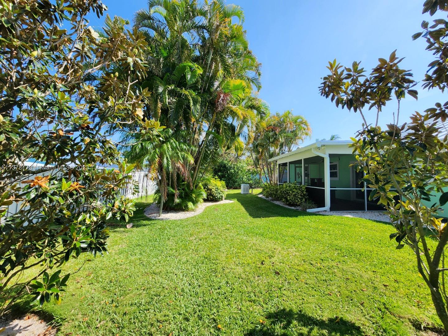 1513 Lance Road Jupiter, FL 33469 - Photo 3 of 33 a view of a house with a yard