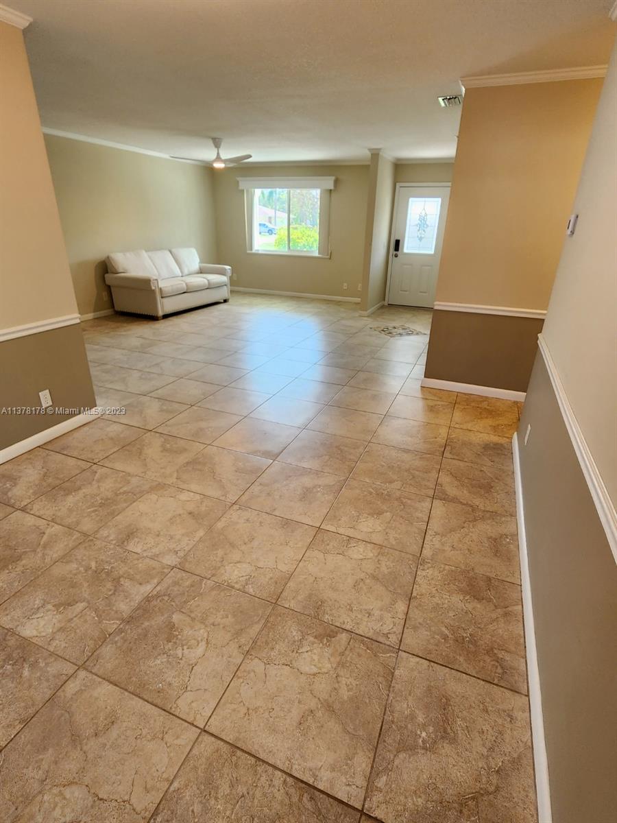 1513 Lance Road Jupiter, FL 33469 - Photo 9 of 33 a view of a livingroom with wooden floor and window