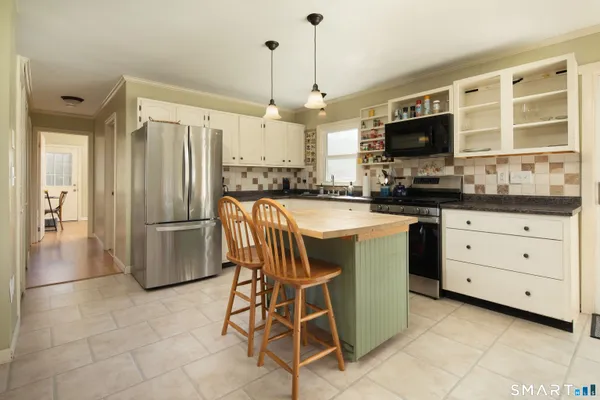 a kitchen with a refrigerator a sink and a stove