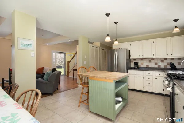 a open kitchen with stainless steel appliances granite countertop a stove and a refrigerator