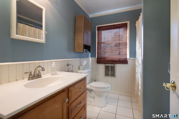 a bathroom with a sink toilet and mirror