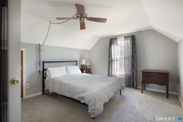 a bedroom with a bed and a chair