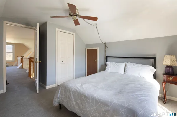 a bedroom with a bed and a walk in closet