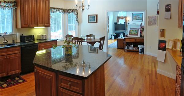 141 Stone School Road Sutton, MA 01590 - Photo 12 of 30 a kitchen with stainless steel appliances granite countertop a stove top oven a dining table and chairs with wooden floor