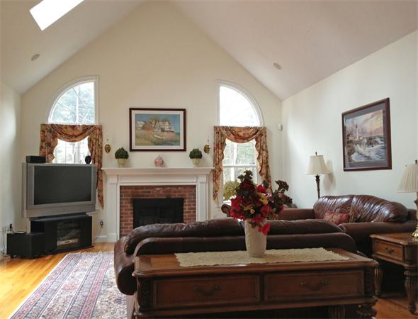 141 Stone School Road Sutton, MA 01590 - Photo 14 of 30 a living room with furniture a fireplace and a flat screen tv