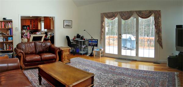 141 Stone School Road Sutton, MA 01590 - Photo 15 of 30 a living room with furniture and a floor to ceiling window