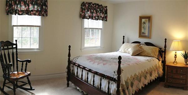 141 Stone School Road Sutton, MA 01590 - Photo 24 of 30 a bedroom with a bed and wooden floor