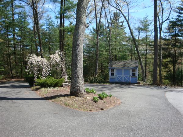 141 Stone School Road Sutton, MA 01590 - Photo 4 of 30 a view of a house with a small yard plants and large trees