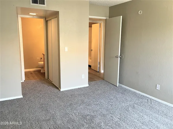 an empty room with a bathroom and a sink