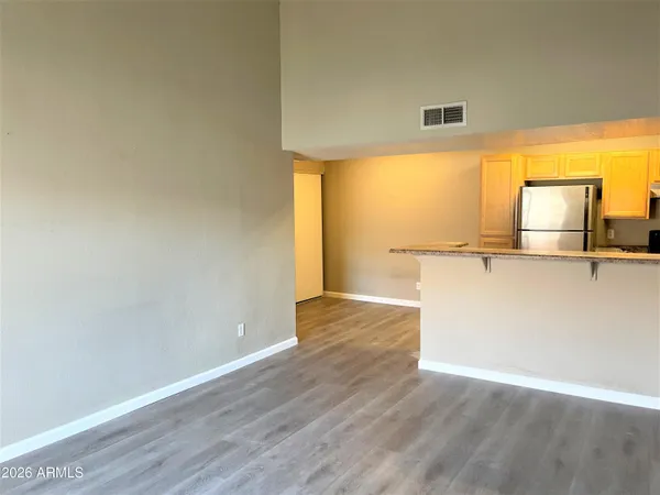 a view of a kitchen with wooden floor and a sink