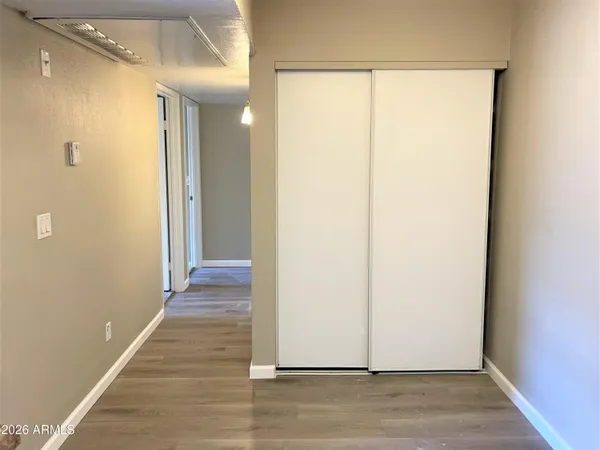 a view of a hallway with wooden floor