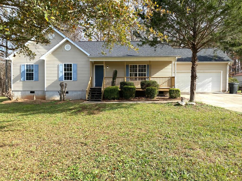 a front view of house with yard outdoor seating and garage