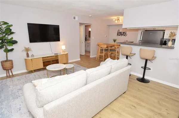 a living room with furniture and a potted plant
