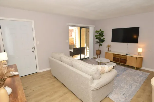 a living room with furniture and a potted plant
