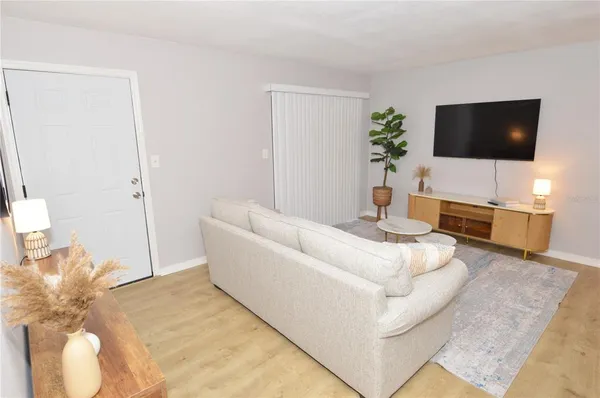 a bedroom with a bed and a potted plant