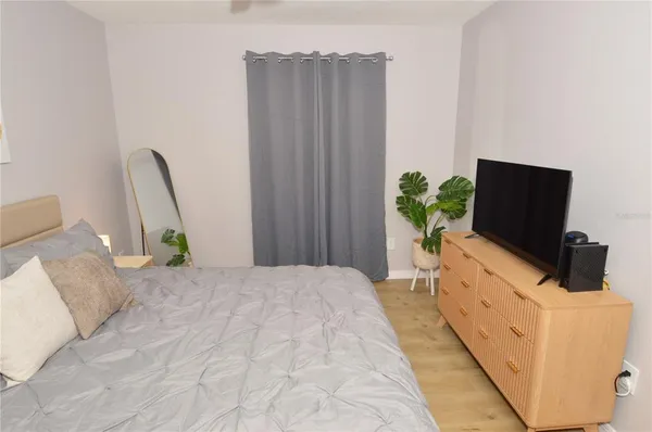 a bedroom with a bed and a flat screen tv