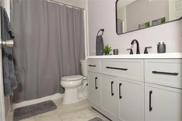 a bathroom with a sink a mirror a vanity and a shower