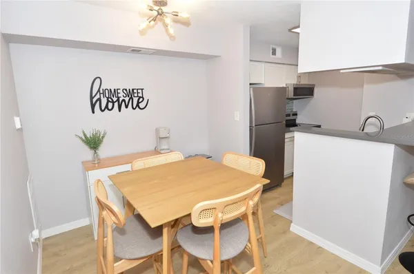 a white refrigerator freezer and a stove sitting inside of a kitchen