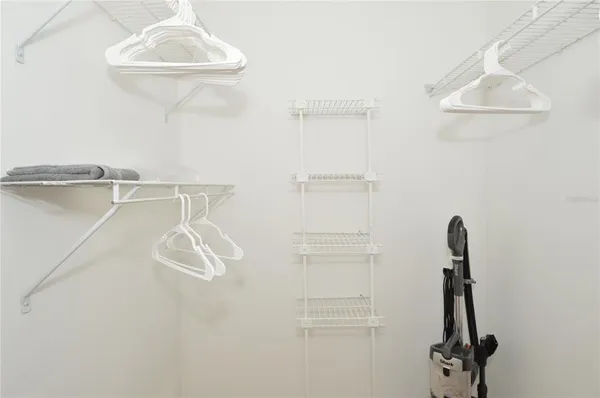 a view of a patio with table and chairs under an umbrella