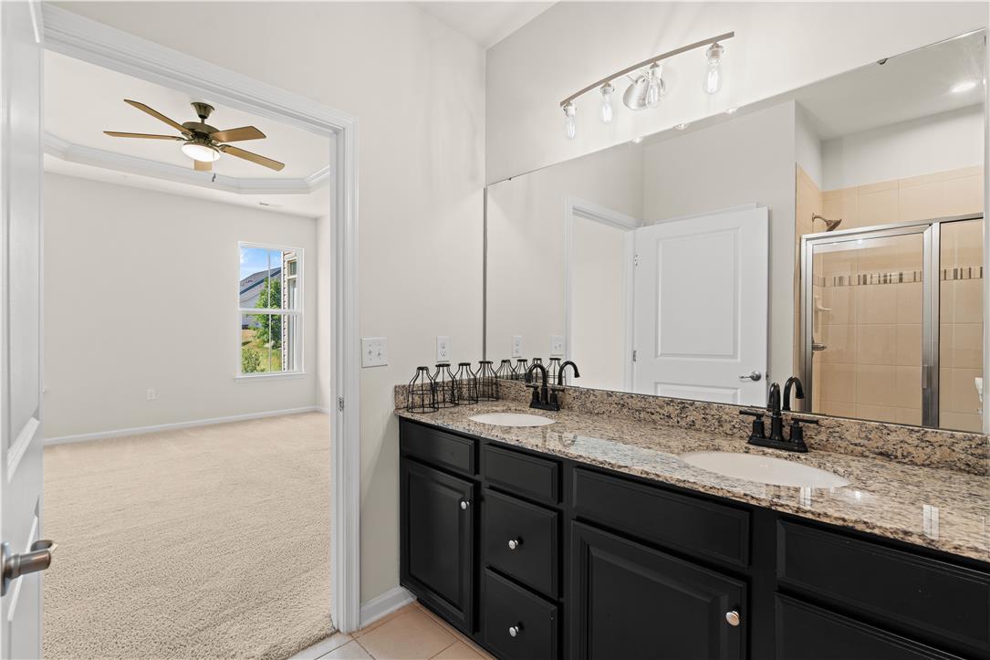 4758 Rafi Road Easton, PA 18045 - Photo 48 of 55 Double vanity with granite counters leads to a well-lit primary bedroom.