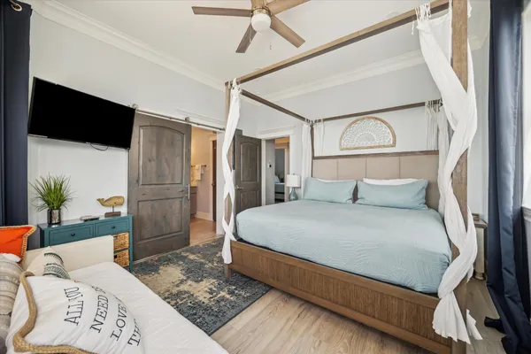 a bed sitting in a bedroom next to a larger window