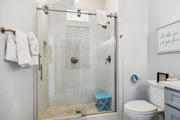 a bathroom with a shower a toilet and a sink