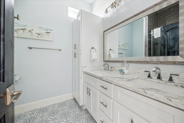 a bathroom with a granite countertop sink and a mirror