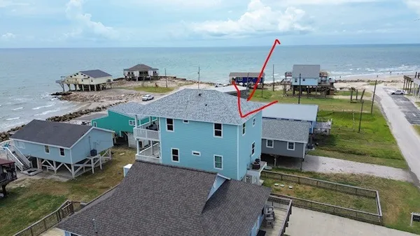 a view of a house with roof deck and living room