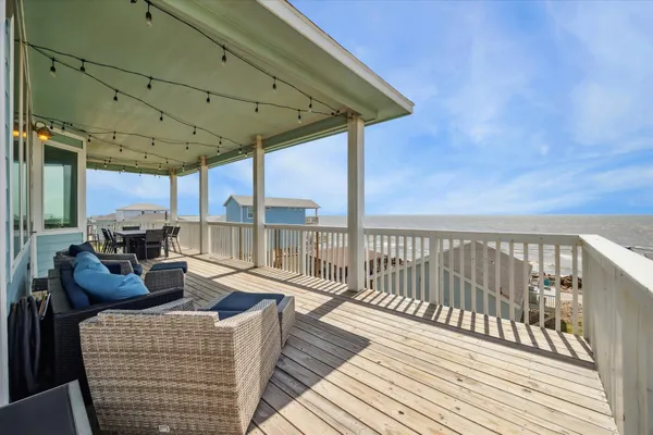 a balcony with furniture and wooden floor