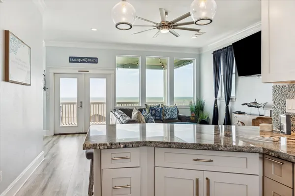 a kitchen with granite countertop a sink and a refrigerator