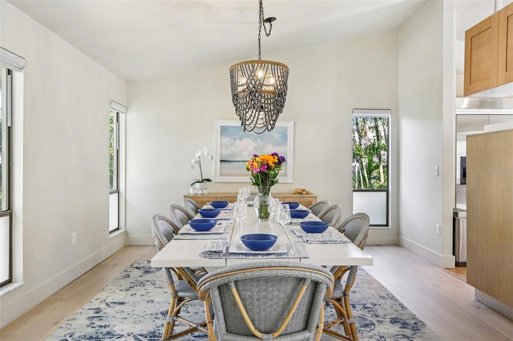 3390 Bayou Sound Longboat Key, FL 34228 - Photo 29 of 59 a view of a dining room with furniture window and wooden floor