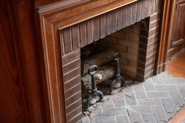 a view of a door of the house with a fireplace