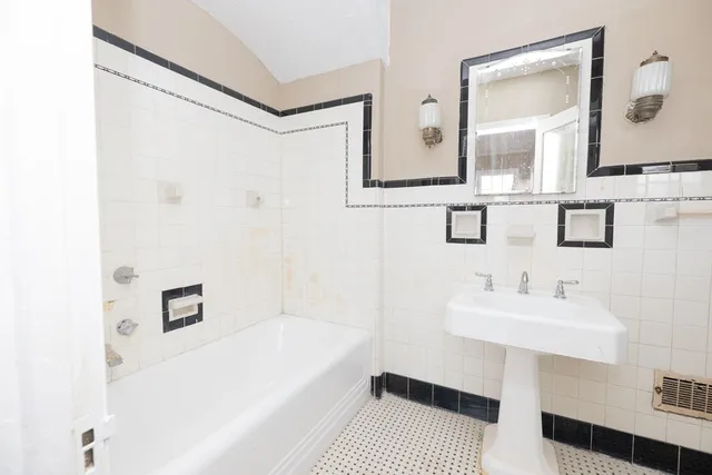 a view of a livingroom with furniture window wooden floor and front door