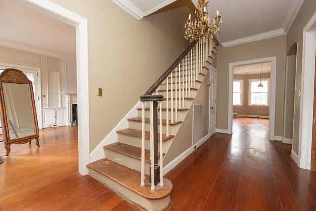 a view of entryway and hall with wooden floor