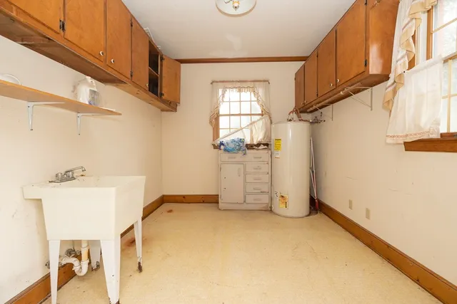 a view of a livingroom with wooden floor and a ceiling fan