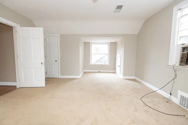 a view of a porch with furniture and floor to ceiling window