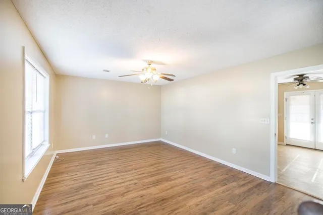 wooden floor in an empty room with a window