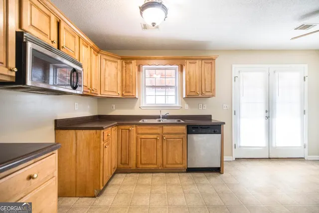a kitchen with stainless steel appliances granite countertop a stove and a sink