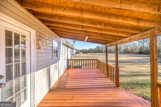 a bathroom with a granite countertop double vanity and a mirror