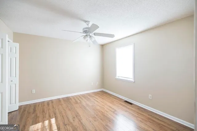 wooden floor in an empty room with a window
