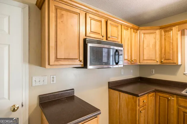 a kitchen with a refrigerator a sink and cabinets