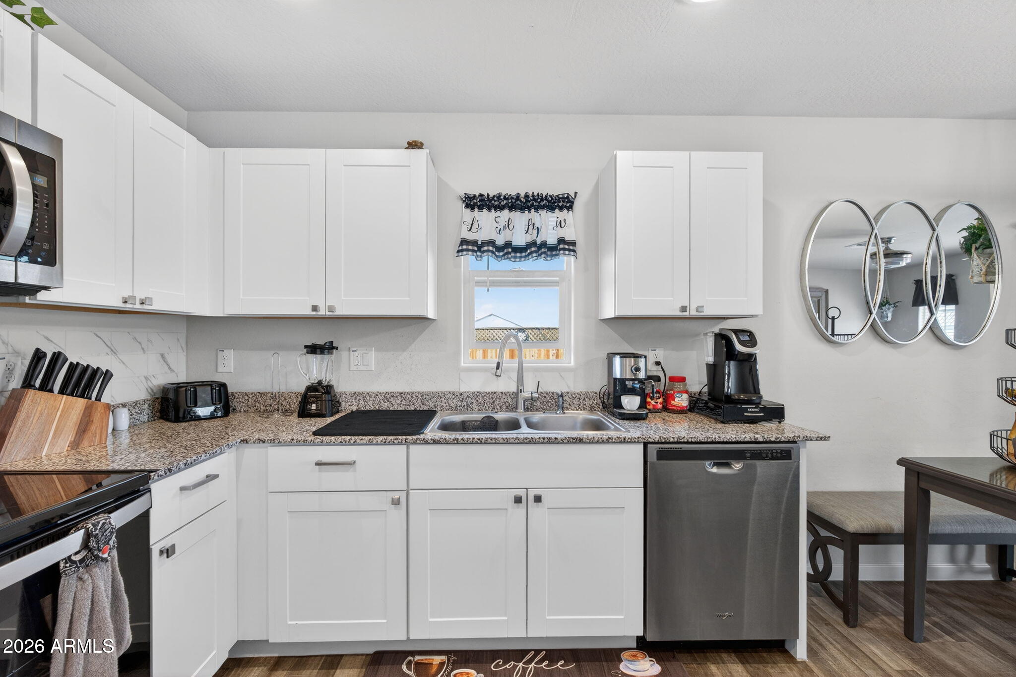 14423 South Capistrano Road Arizona City, AZ 85123 - Photo 12 of 36 a kitchen with stainless steel appliances granite countertop a sink stove and cabinets