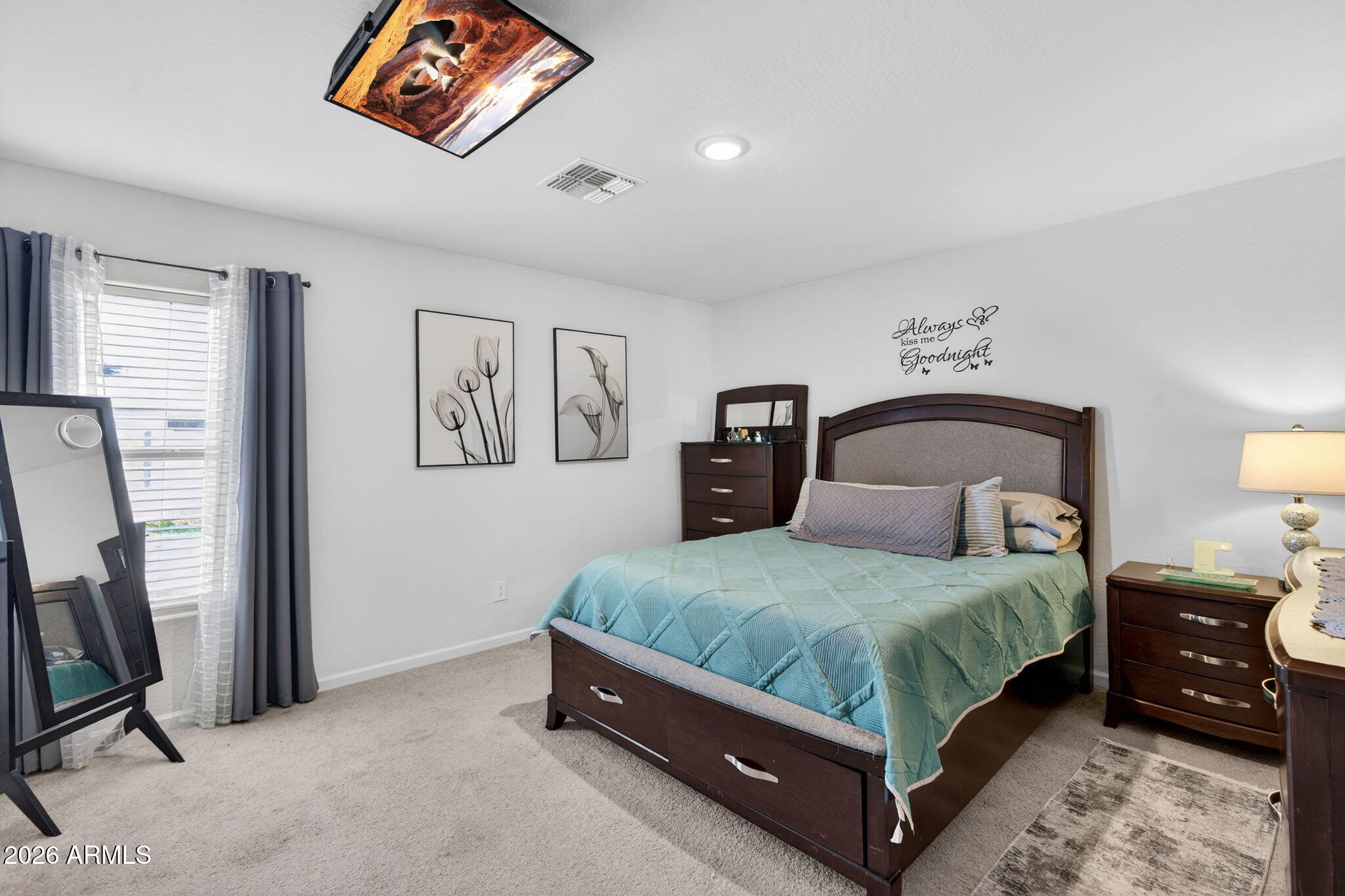 14423 South Capistrano Road Arizona City, AZ 85123 - Photo 17 of 36 a bedroom with a bed a couch and painting on the wall