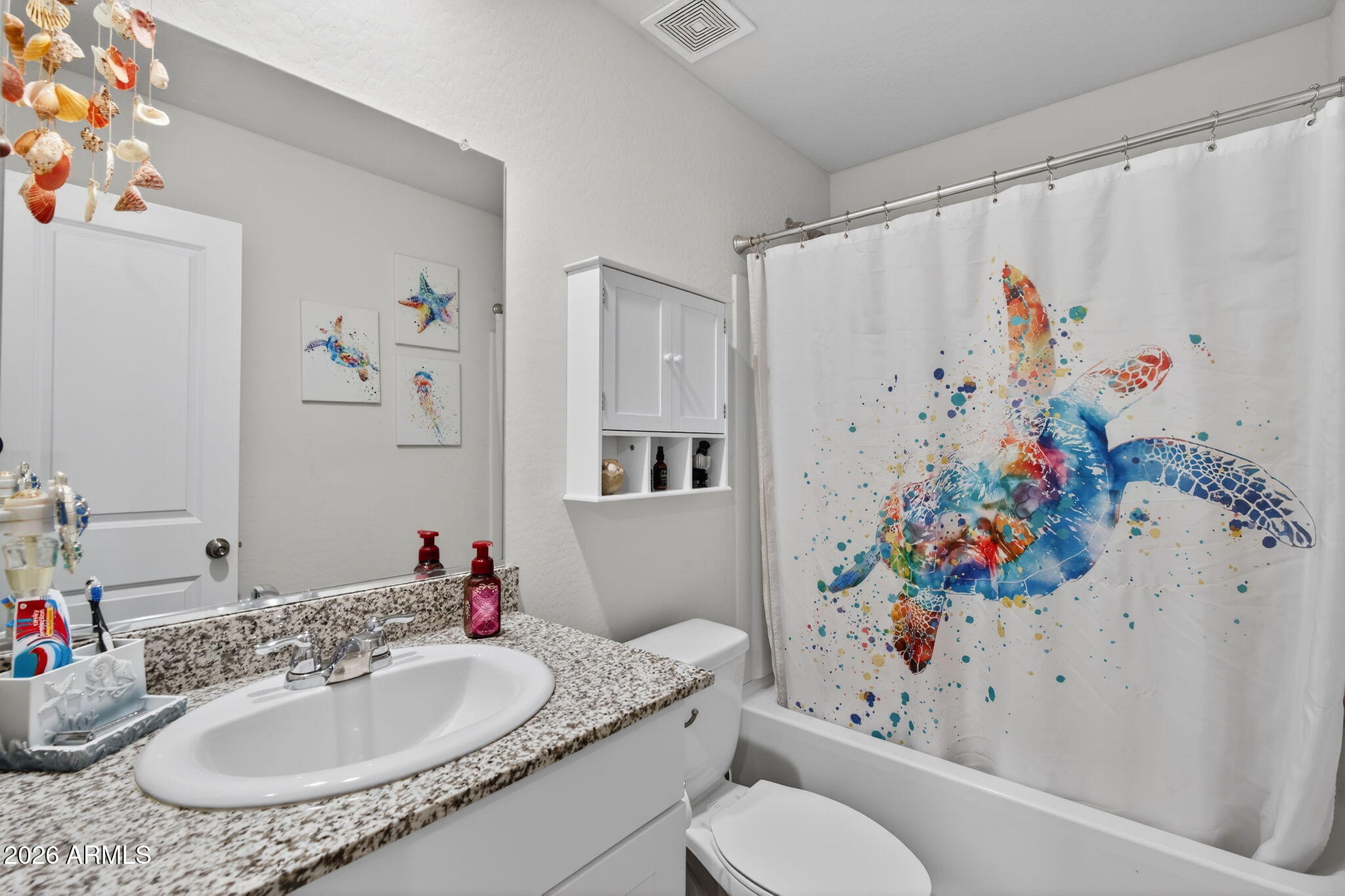 14423 South Capistrano Road Arizona City, AZ 85123 - Photo 21 of 36 a bathroom with a toilet sink and mirror