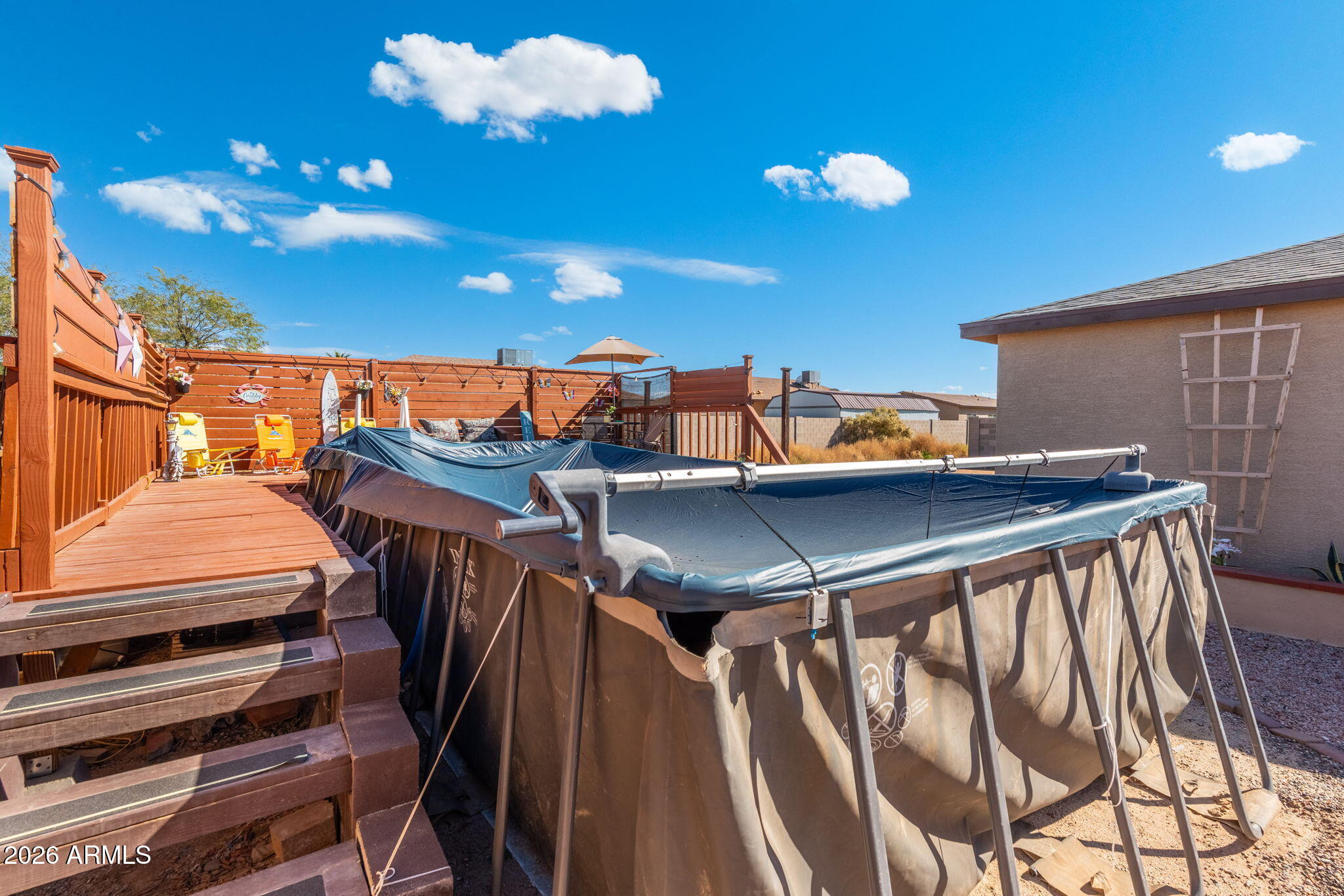 14423 South Capistrano Road Arizona City, AZ 85123 - Photo 32 of 36 a view of a balcony with chairs and wooden floor