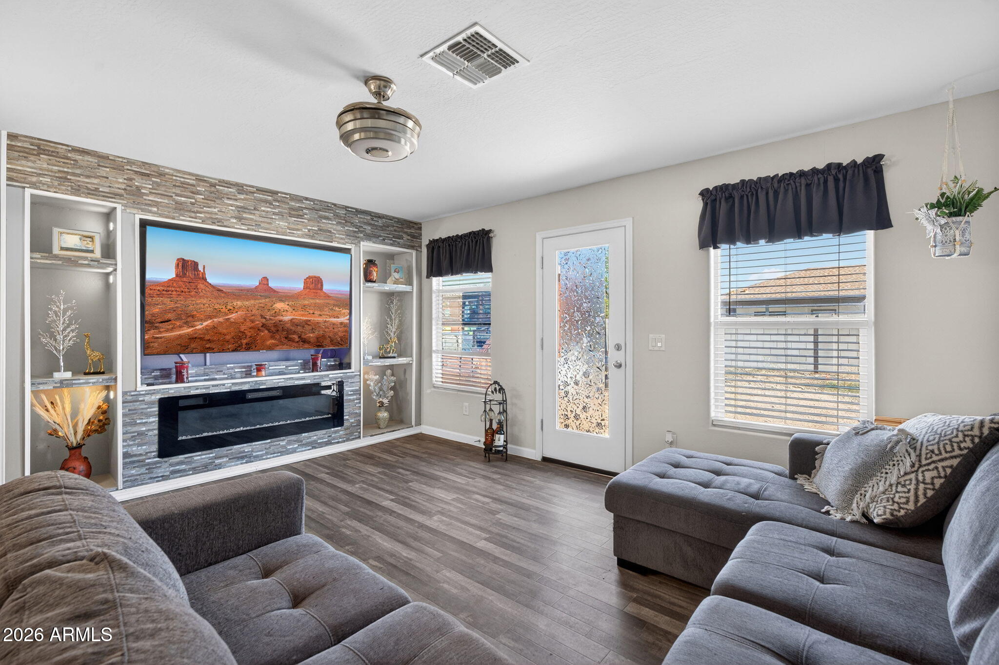 14423 South Capistrano Road Arizona City, AZ 85123 - Photo 5 of 36 a living room with furniture and a flat screen tv