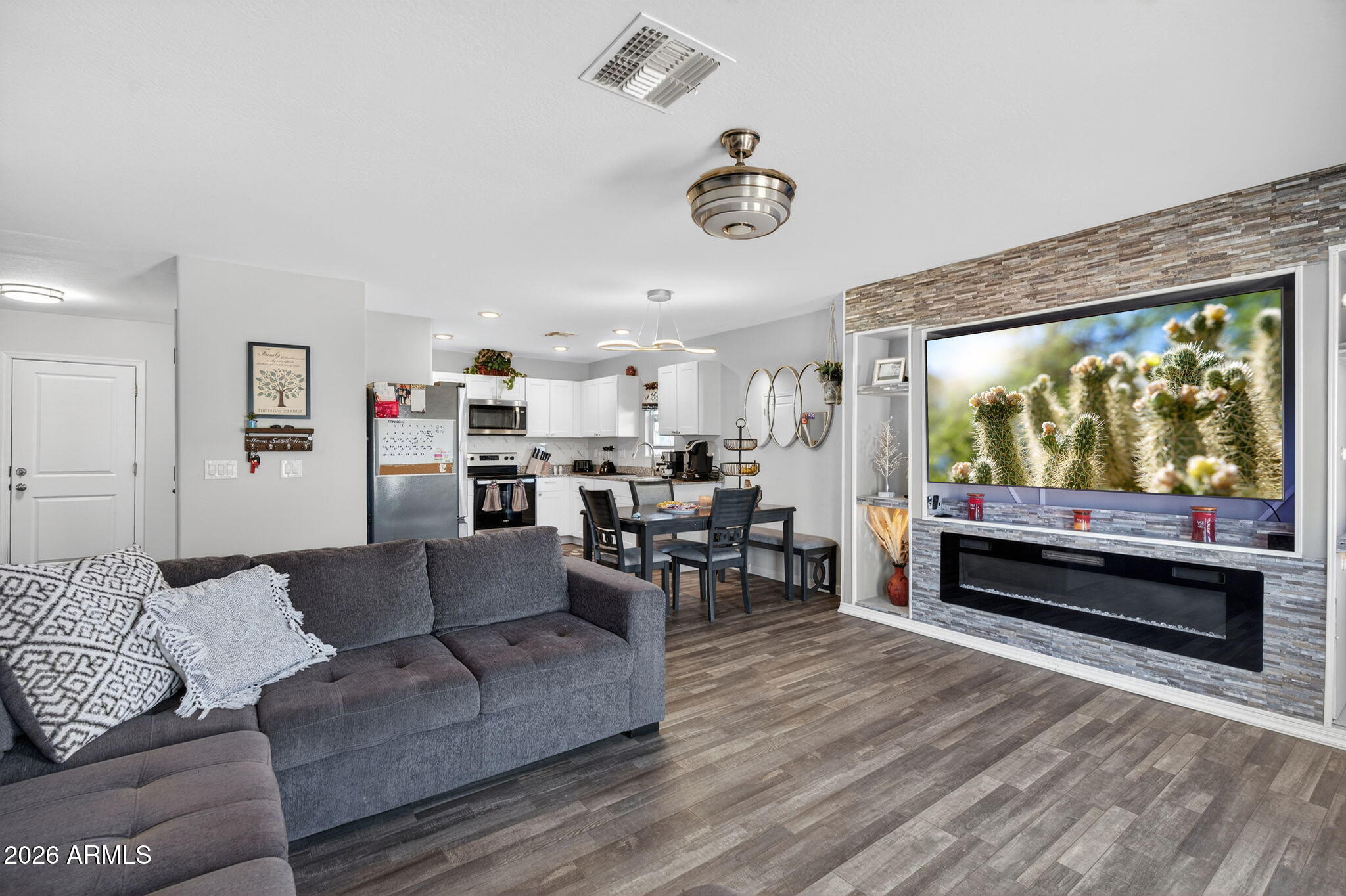 14423 South Capistrano Road Arizona City, AZ 85123 - Photo 8 of 36 a living room with furniture and a flat screen tv