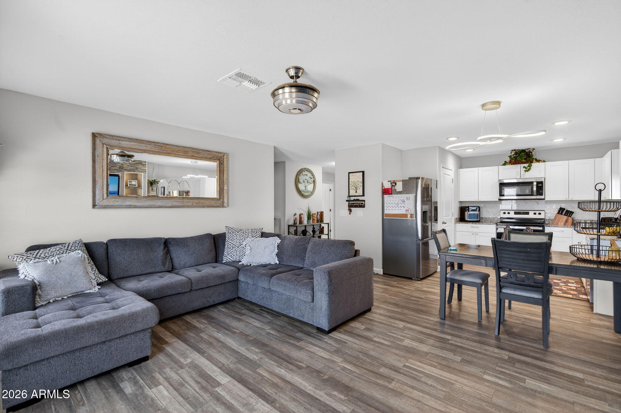 14423 South Capistrano Road Arizona City, AZ 85123 - Photo 9 of 36 a living room with furniture kitchen view and a dining table