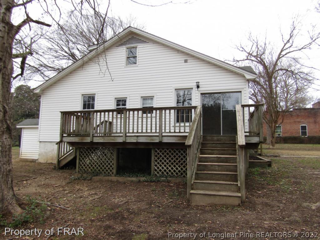 216 Post Office Road Moncure, NC 27559 - Photo 4 of 16 a view of a house with backyard and trees